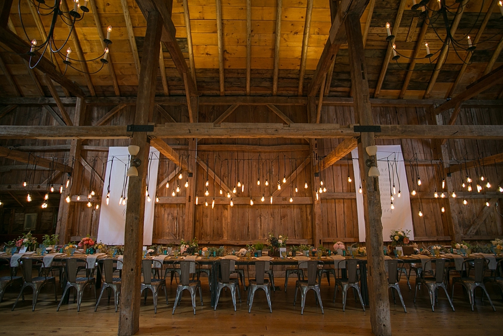 Rustic barn wedding with hanging edison bulb lights