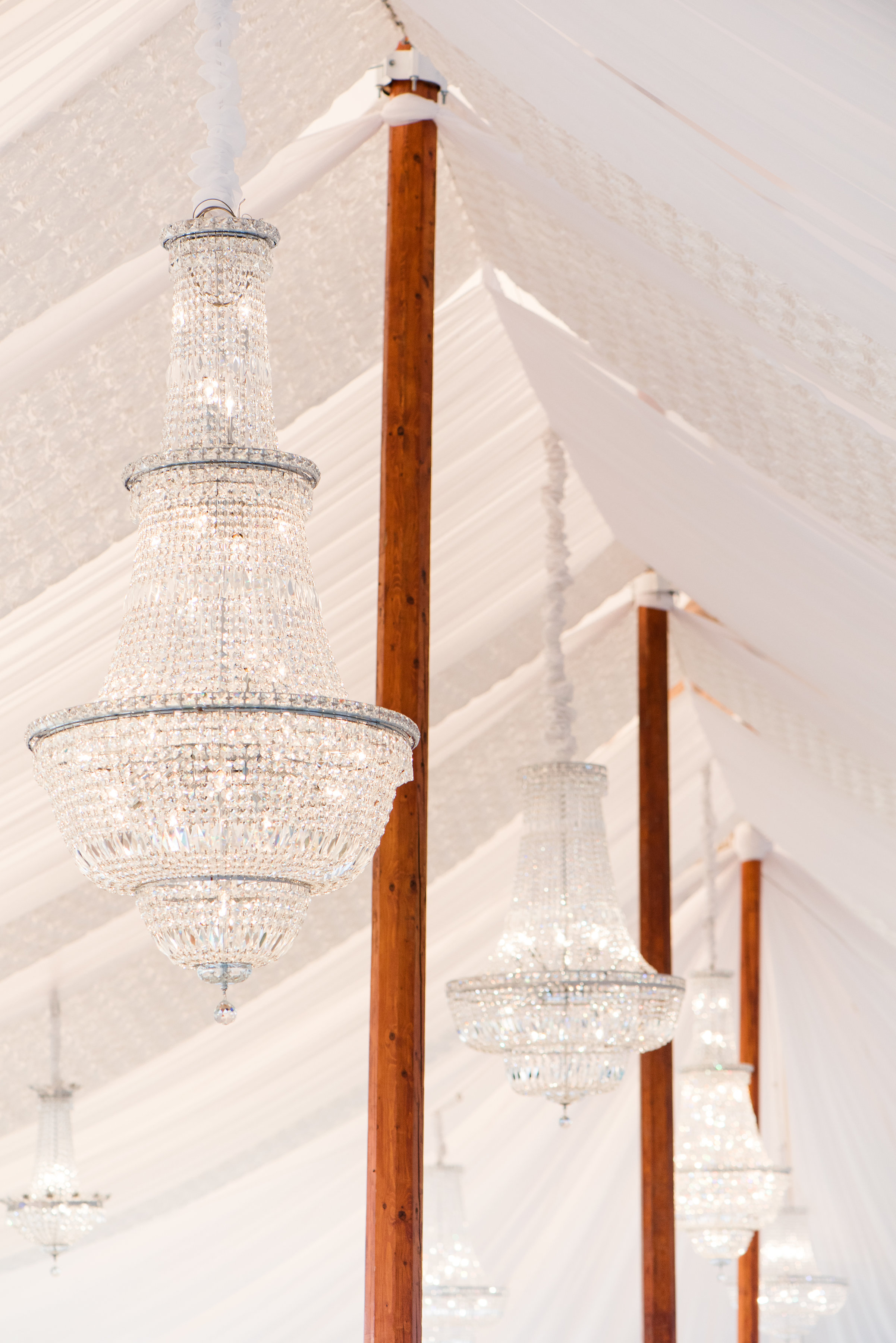 Romantic draped Sperry Tent with Chrystal Chandeliers via Jubilee Events