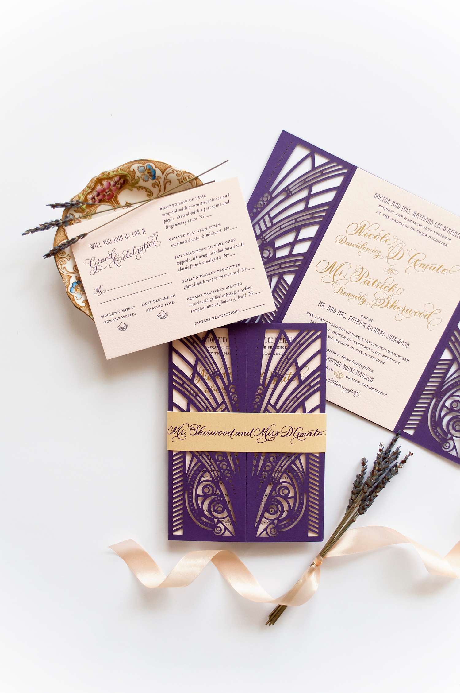 Gatsby themed wedding invites in blush pink, purple, and gold with letter press and laser cut details.