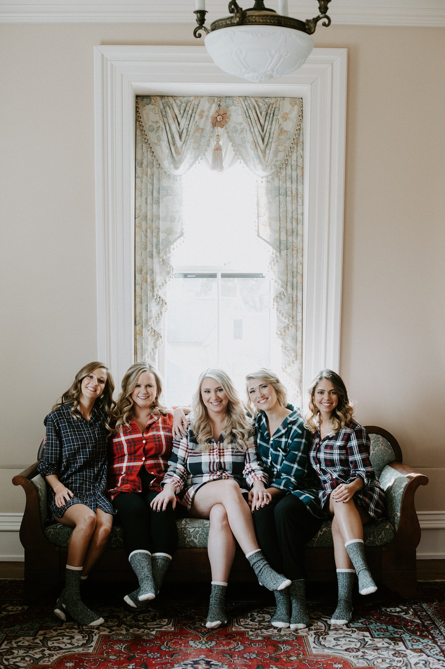 Bride and bridesmaids getting ready in flannel robes at The Webb Barn