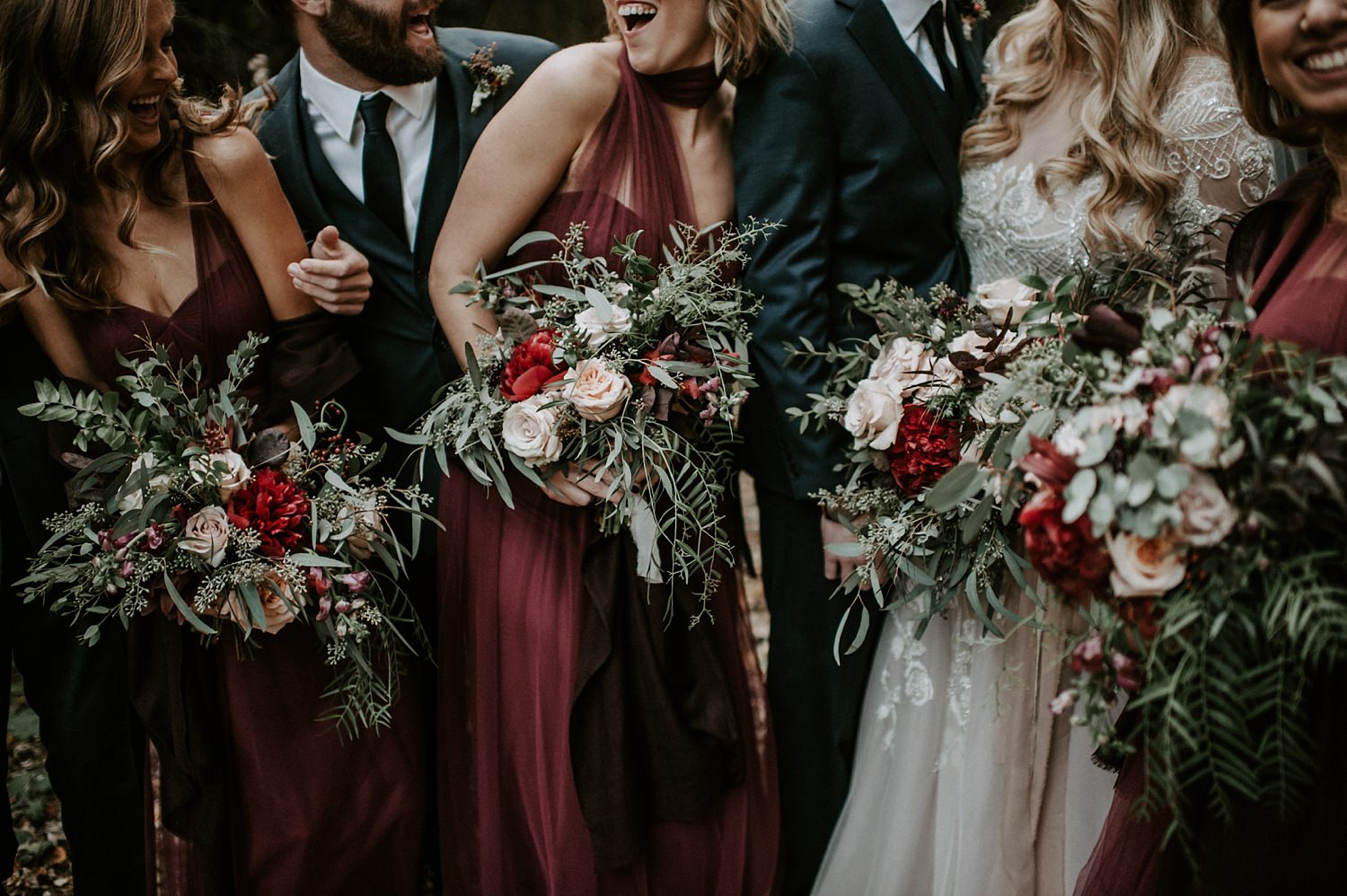 Rustic bridesmaids bouquets in marsala, blush, red, green and ivory