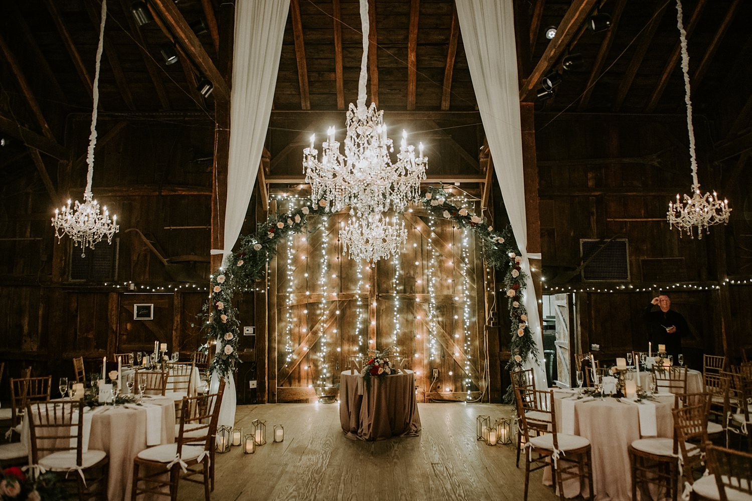 Glamorous and rustic wedding with draping and chandeliers at The Webb Barn in Wethersfield, CT