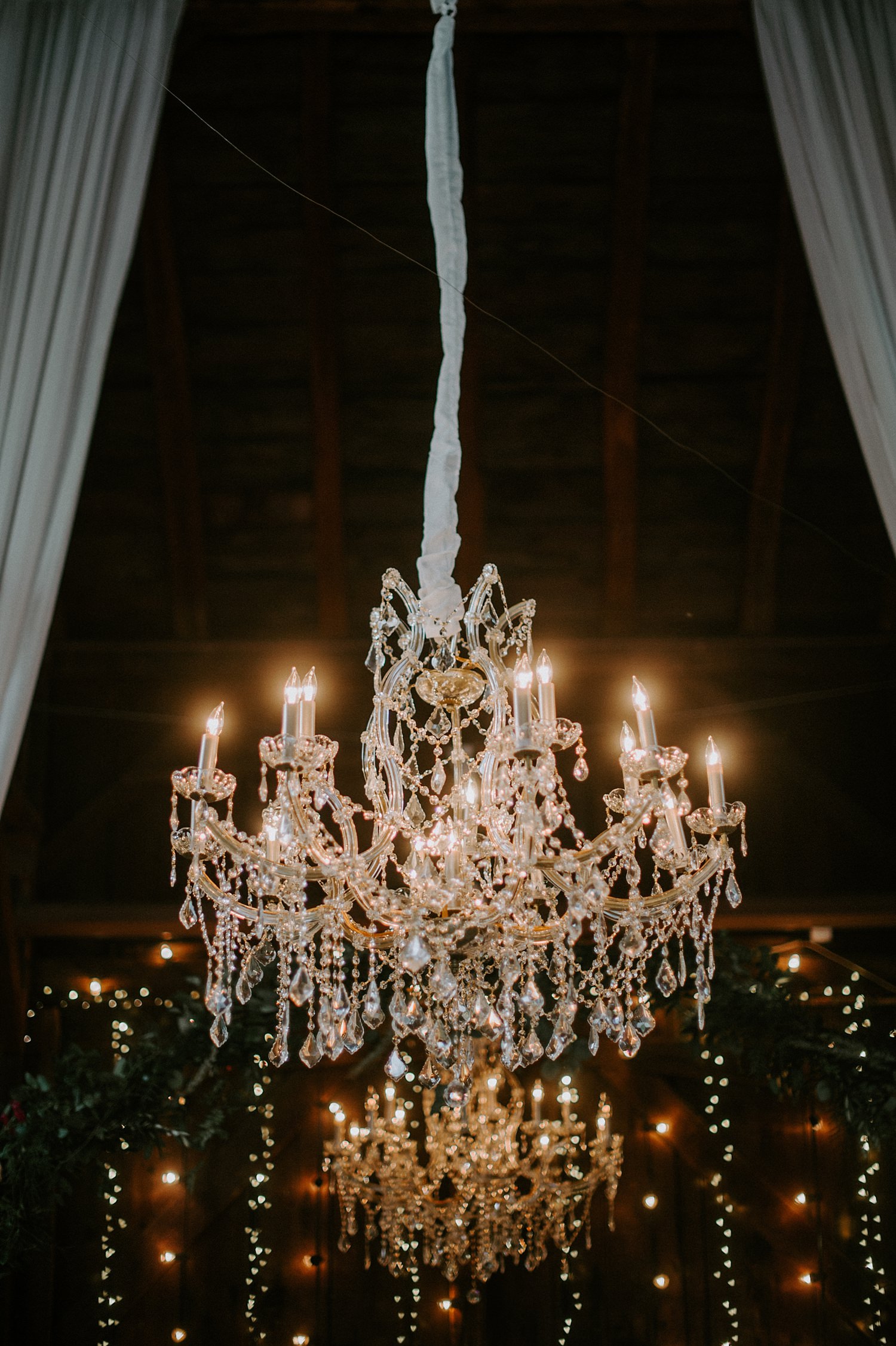 Glamorous and rustic wedding with draping and chandeliers at The Webb Barn in Wethersfield, CT