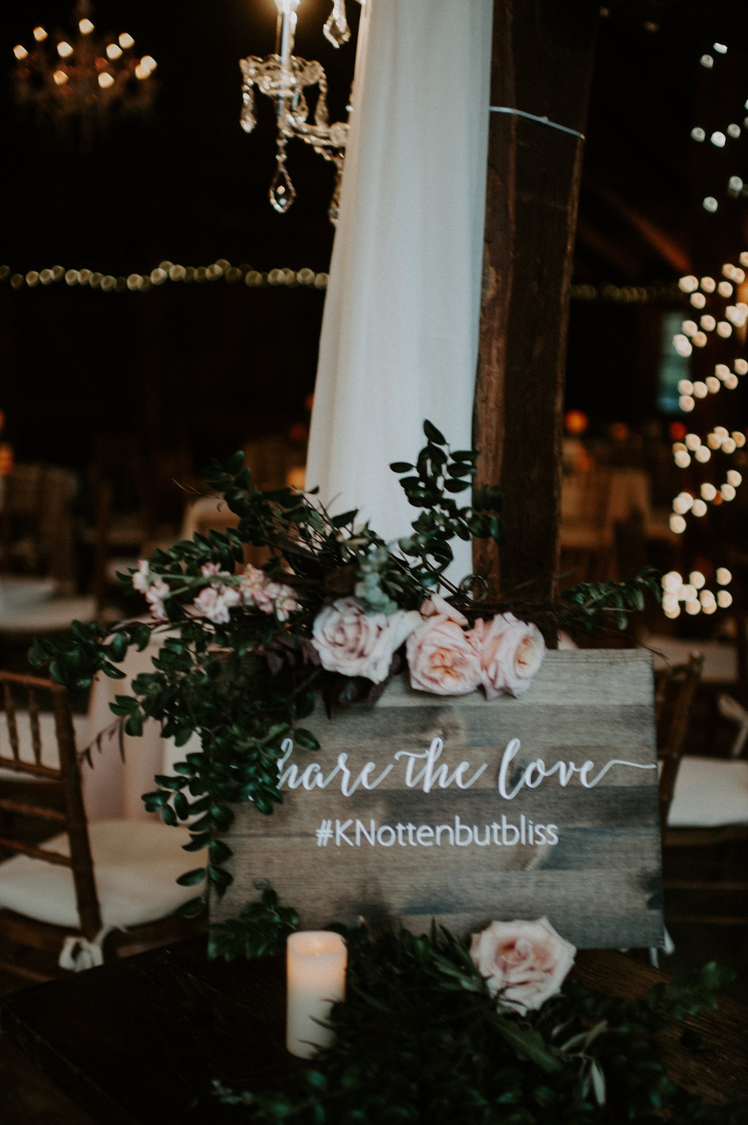 Rustic wooden wedding hashtag sign at The Webb Barn